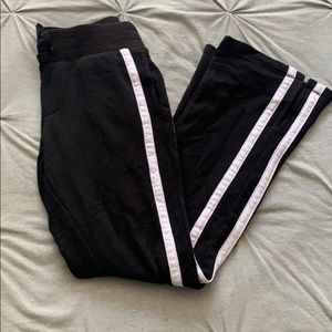 Black sweatpants with white stripes on sides